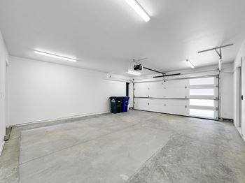 the interior of a garage with a white wall and a garage door  at Matilda 235 Townhomes, Des Moines, 50309